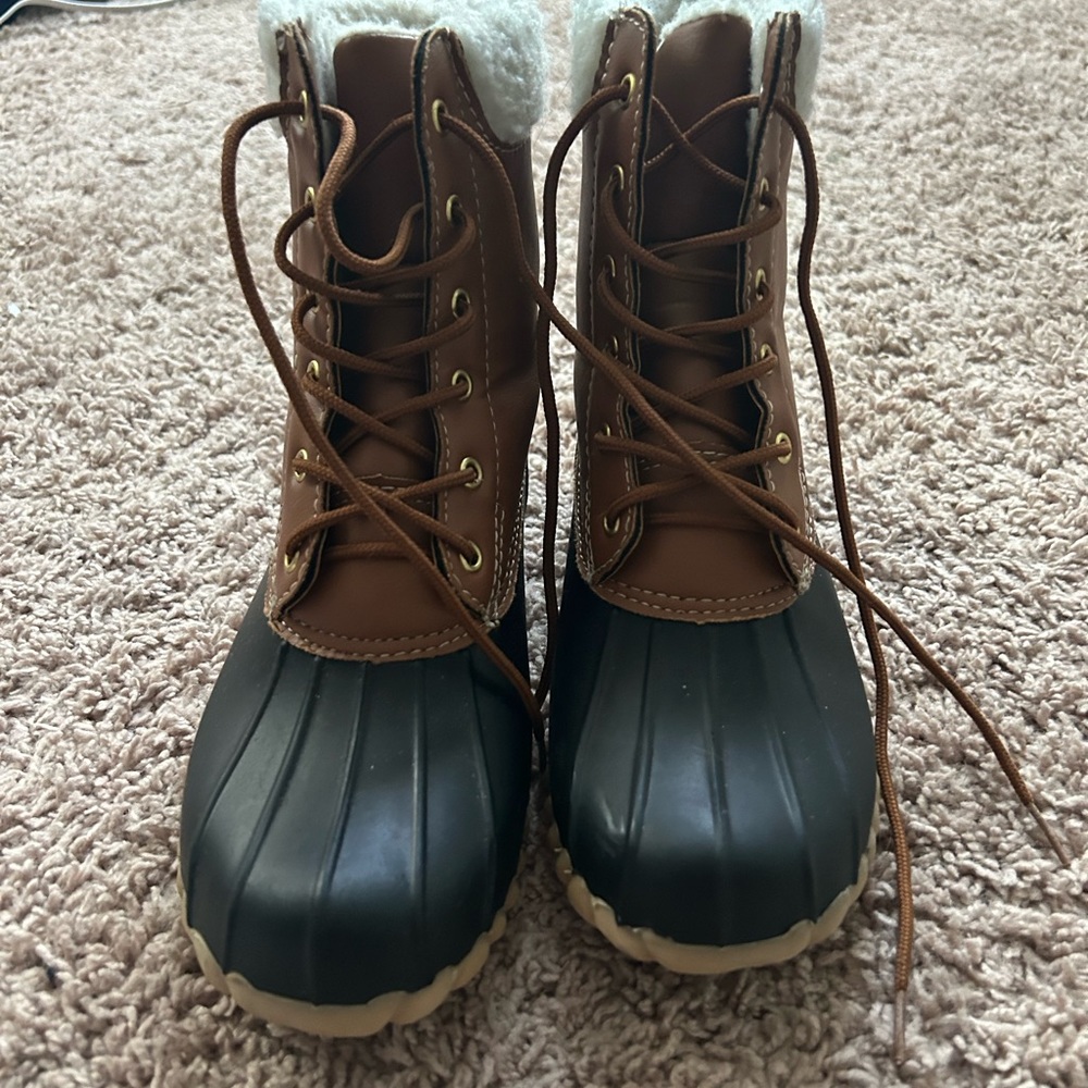 Brown and black duck boots